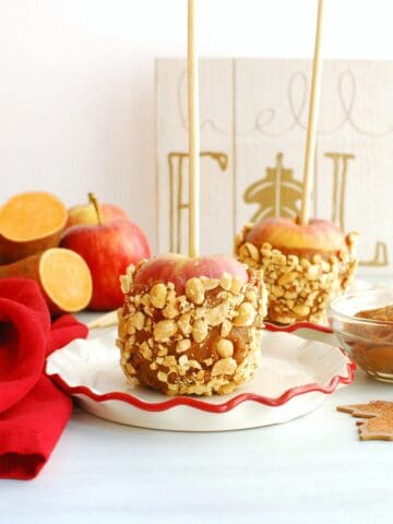 A healthy caramel apple with sweetpotato-date caramel on a small plate.